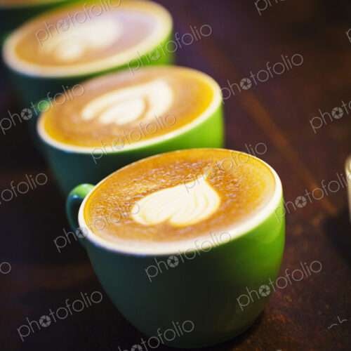 Specialist coffee shop. Cups of coffee with patterns in the froth on the top. Specialist coffee shop. Cups of coffee with patterns in the froth on the top.