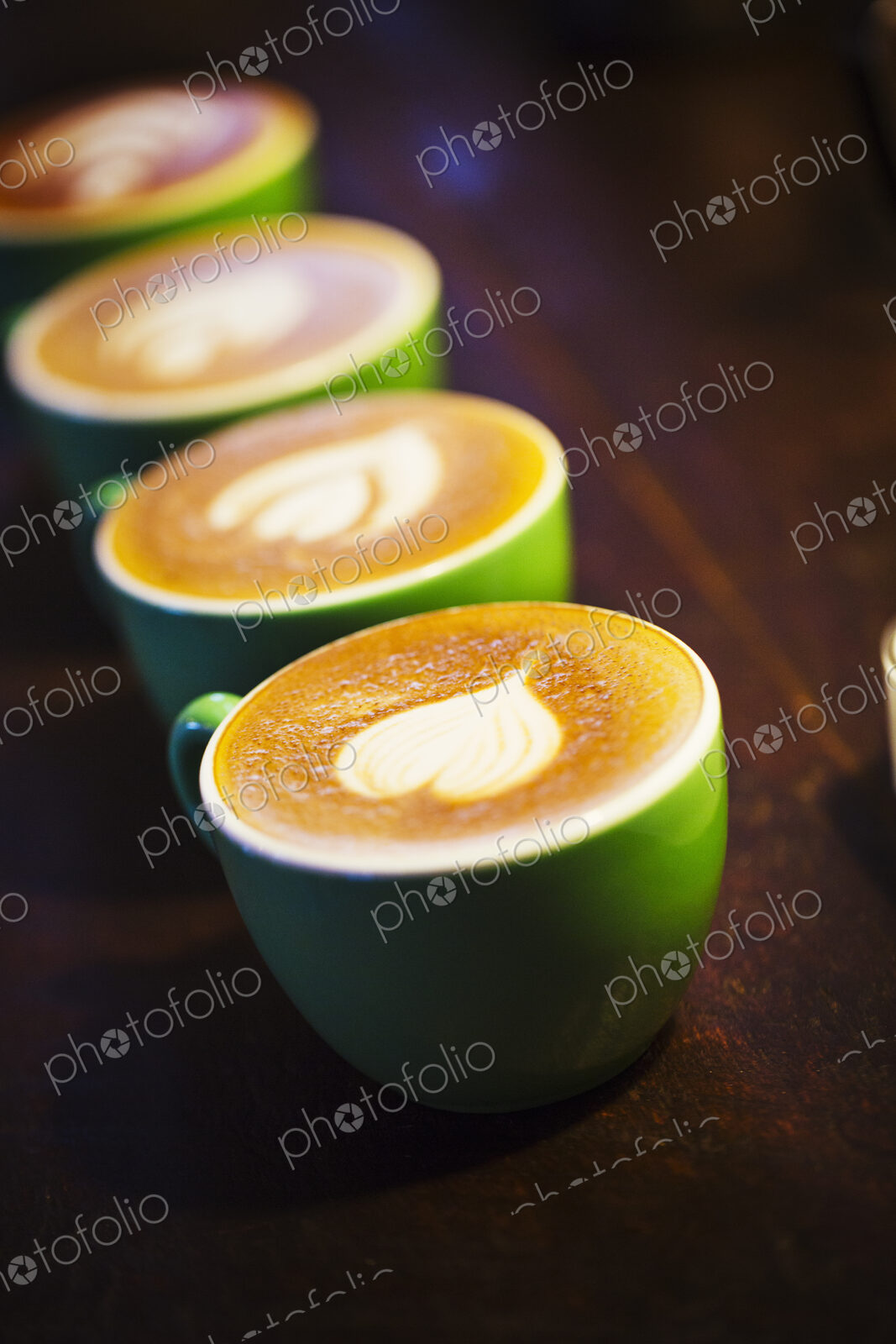 Specialist coffee shop. Cups of coffee with patterns in the froth on the top.