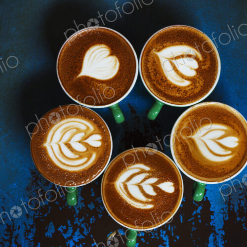 Specialist coffee shop. Cups of coffee with patterns in the froth on the top. Specialist coffee shop. Cups of coffee with patterns in the froth on the top.