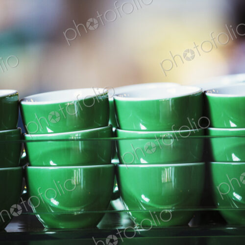 Specialist coffee shop. Green coffee cups stacked up. Specialist coffee shop. Green coffee cups stacked up.