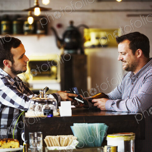 Specialist coffee shop. Two men, a barista and a client talking over the coffee shop… Specialist coffee shop. Two men, a barista and a client talking over the coffee shop…