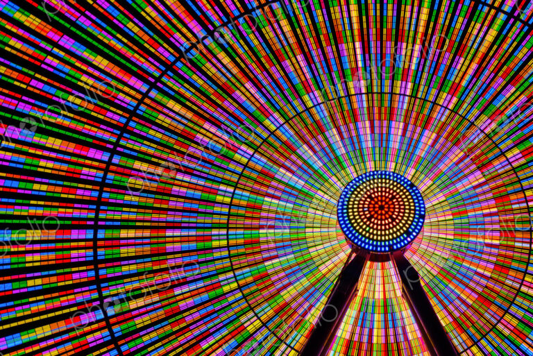 Spinning ferris wheel illuminated at night