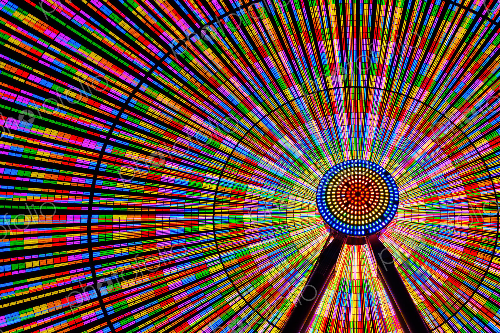 Spinning ferris wheel illuminated at night