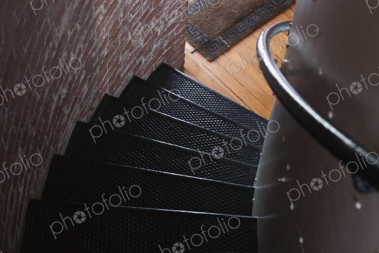 Spiral stairs, a staircase with a railing twisting and turning in a small space, a…