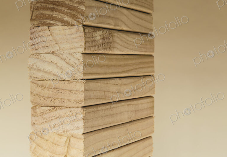 Stack of sawn prepared timber, spruce wood planks or studs, for use. Treated wood in…