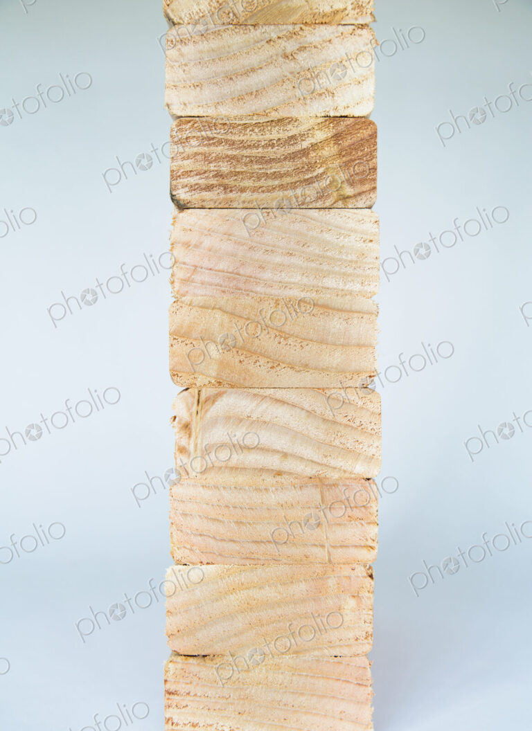 Stack of sawn prepared timber, spruce wood planks or studs, for use. Treated wood in…