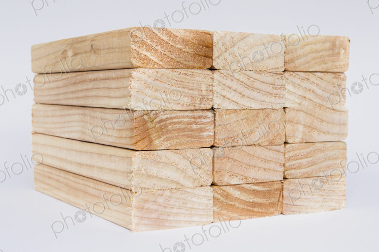 Stack of sawn prepared timber, spruce wood planks or studs, for use. Treated wood in…