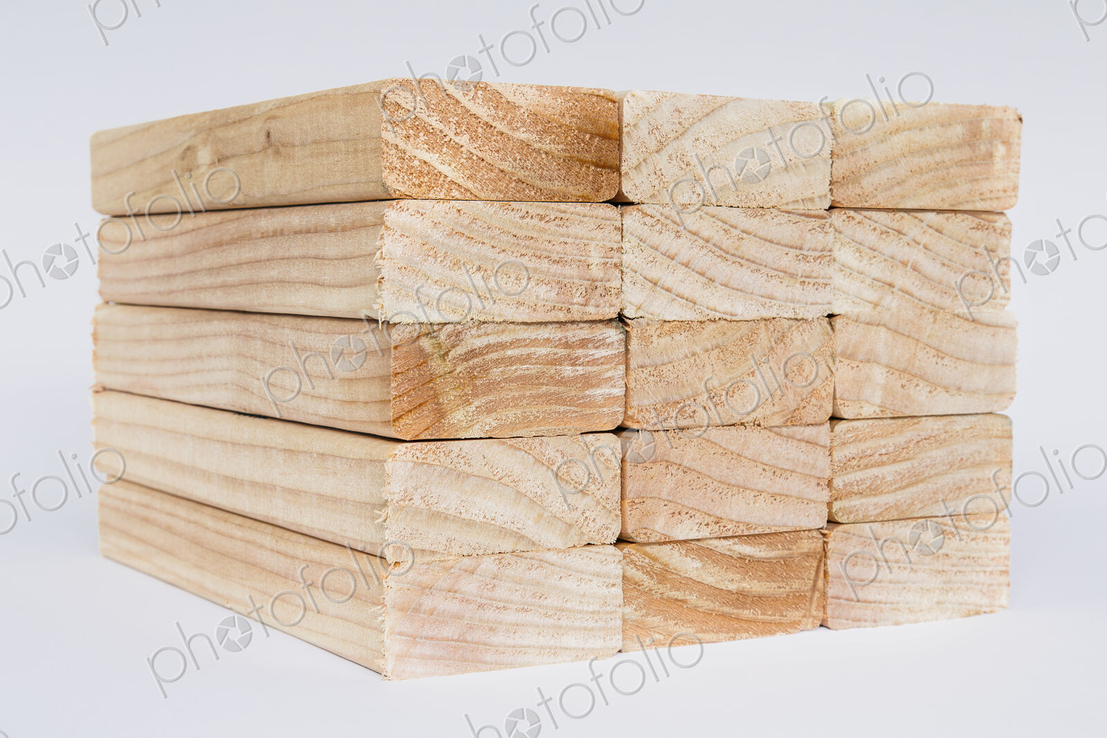 Stack of sawn prepared timber, spruce wood planks or studs, for use. Treated wood in…