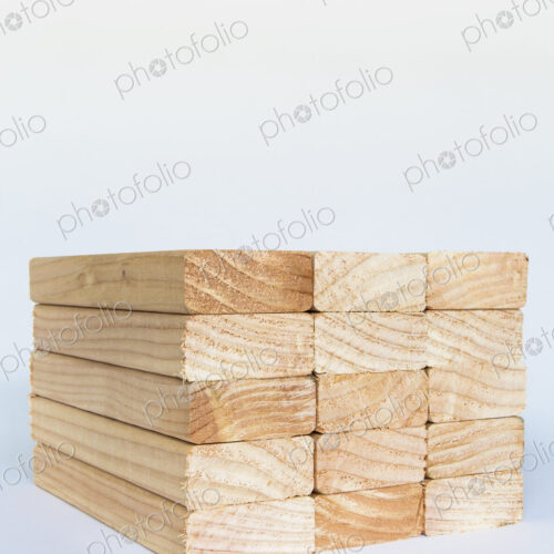 Stack of sawn prepared timber, spruce wood planks or studs, for use. Treated wood in… Stack of sawn prepared timber, spruce wood planks or studs, for use. Treated wood in…