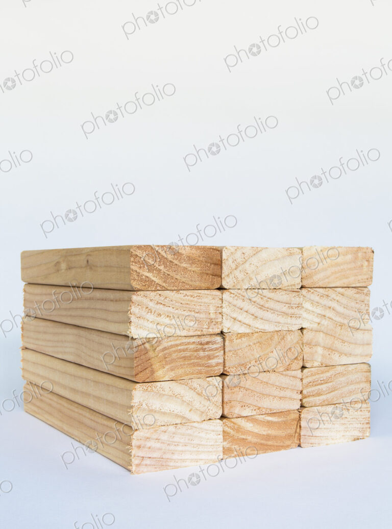 Stack of sawn prepared timber, spruce wood planks or studs, for use. Treated wood in…