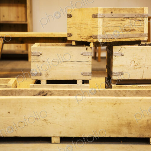 Stack of wooden crates in various sizes in a warehouse.