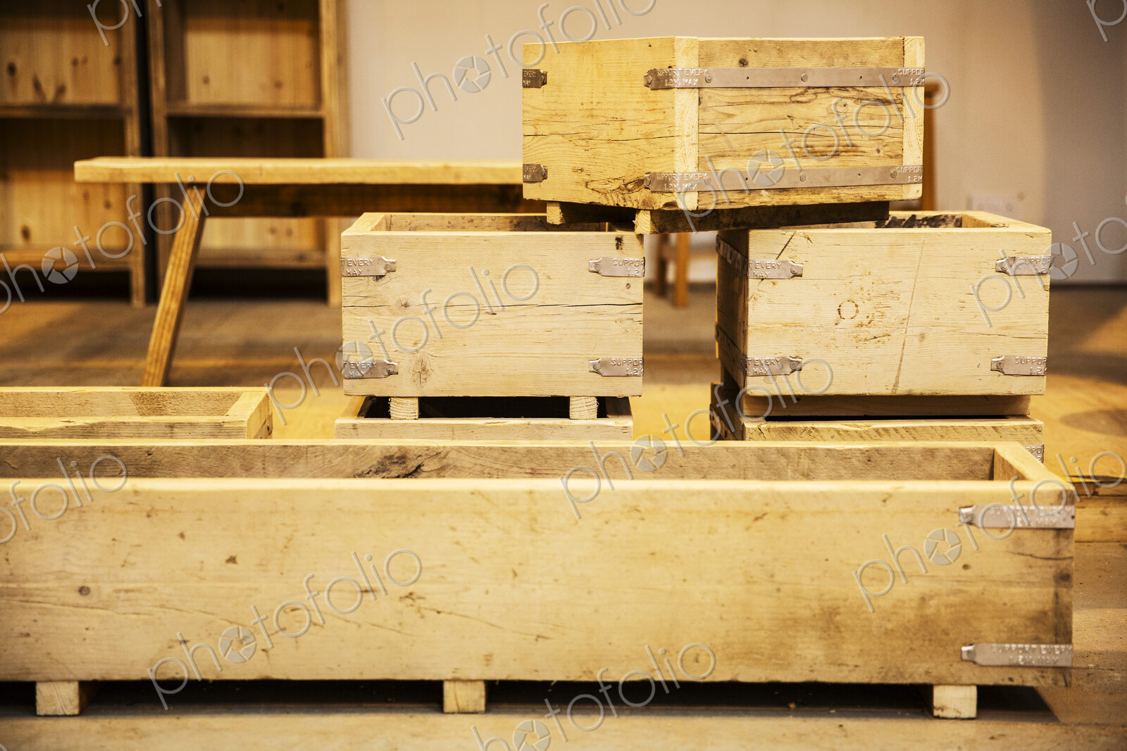 Stack of wooden crates in various sizes in a warehouse.