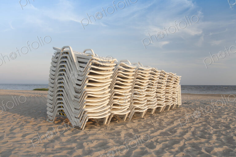 Stacked Lounge Chairs on a Beach