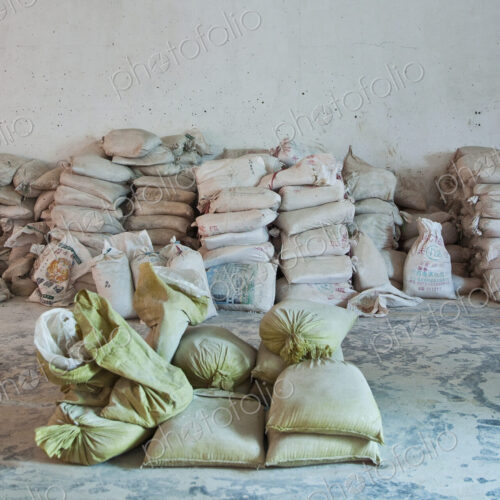 Stacked sacks of flour against a wall, storage Stacked sacks of flour against a wall, storage