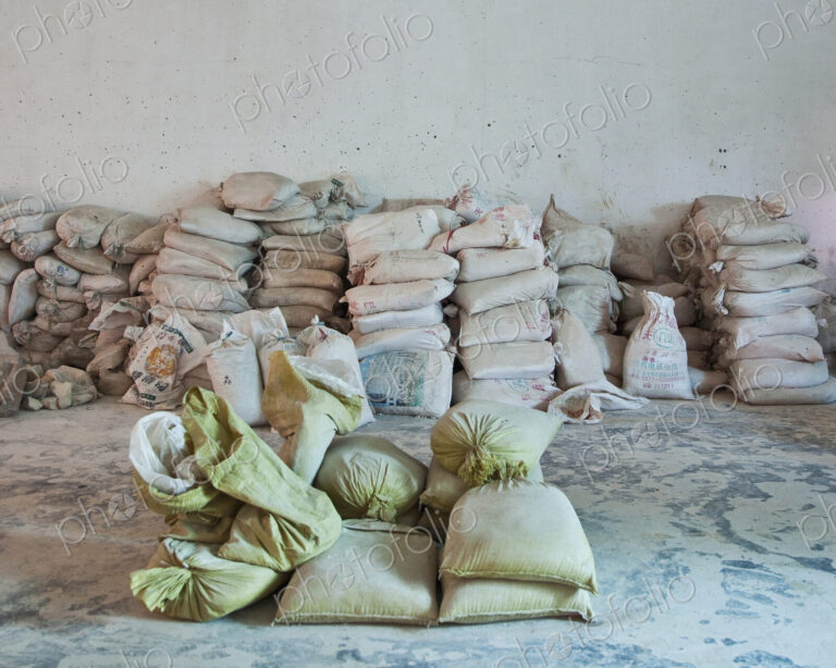 Stacked sacks of flour against a wall, storage