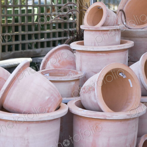 Stacked terracotta pots in garden centre.