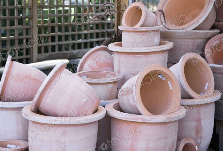 Stacked terracotta pots in garden centre.