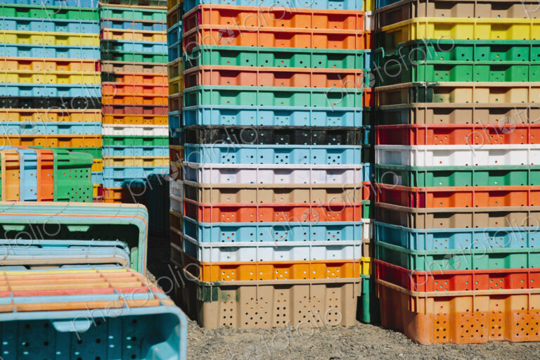 Stacks of multi-colored containers used for harvesting grapes