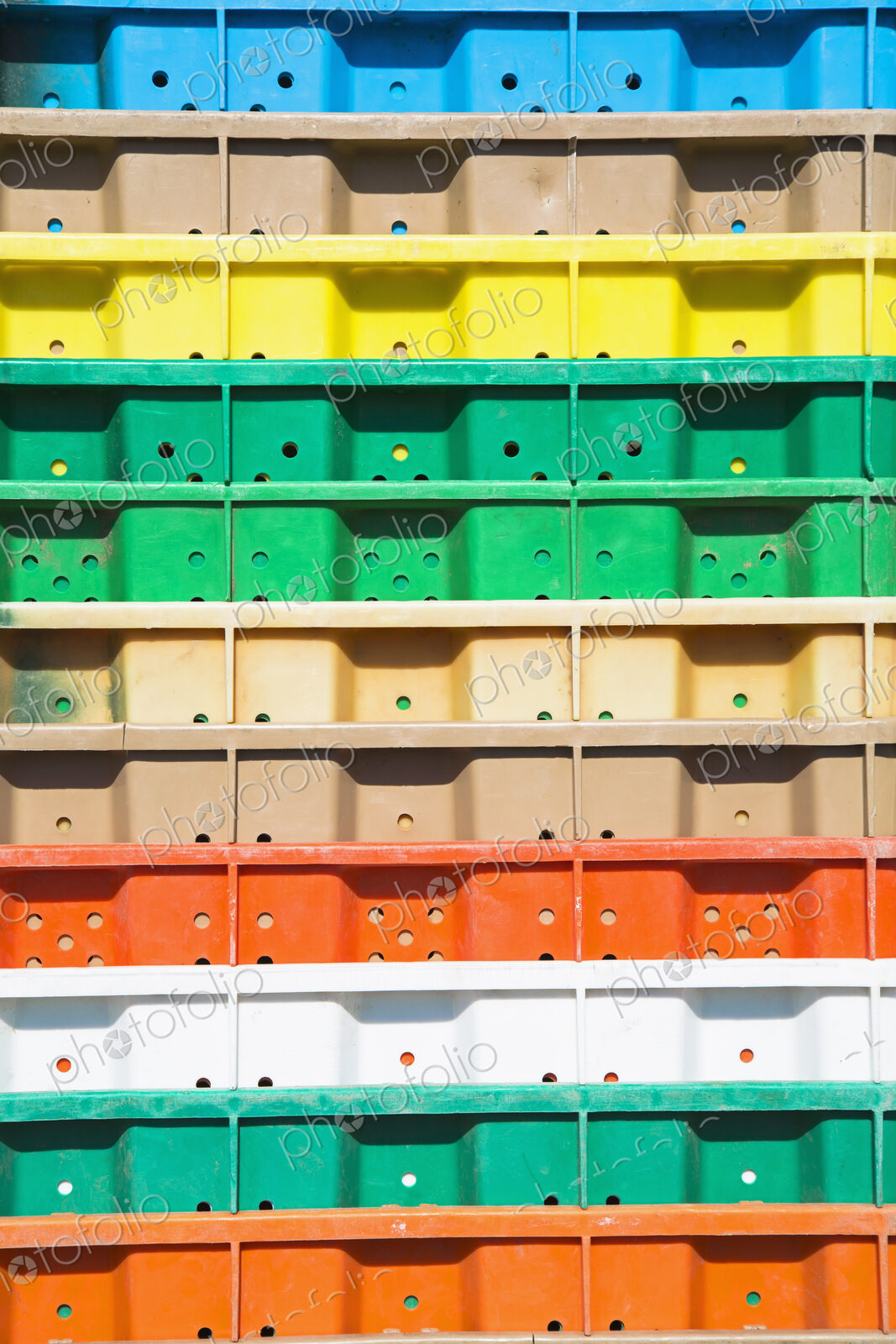 Stacks of multi-colored containers used for harvesting grapes