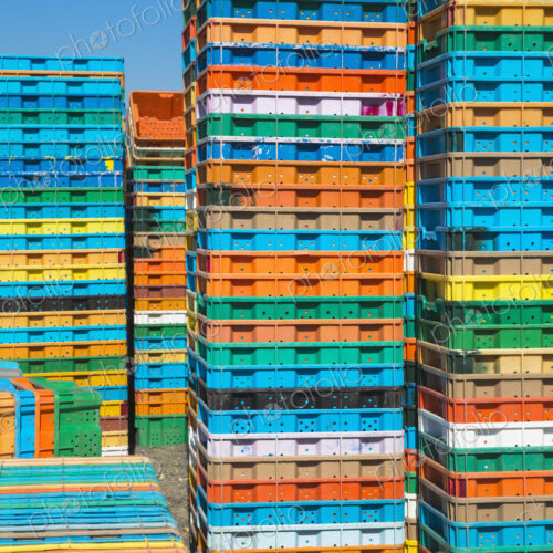 Stacks of multi-colored containers used for harvesting grapes
