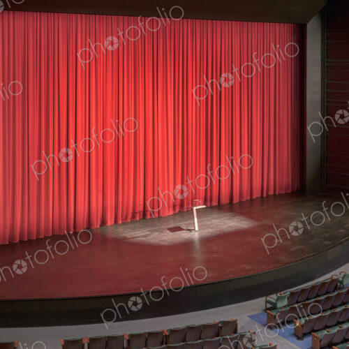 Stage with red curtains in an empty auditorium. Stage with red curtains in an empty auditorium.