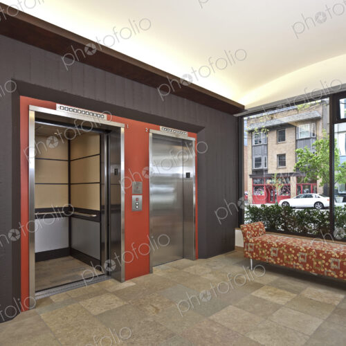 Stainless Steel Elevator Doors And A Bench Seat
