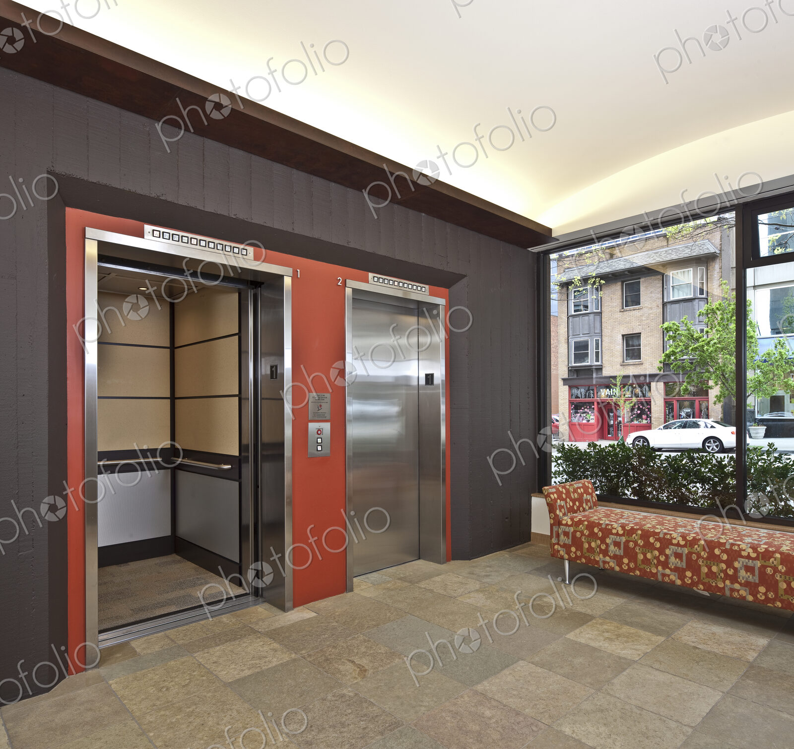 Stainless Steel Elevator Doors And A Bench Seat