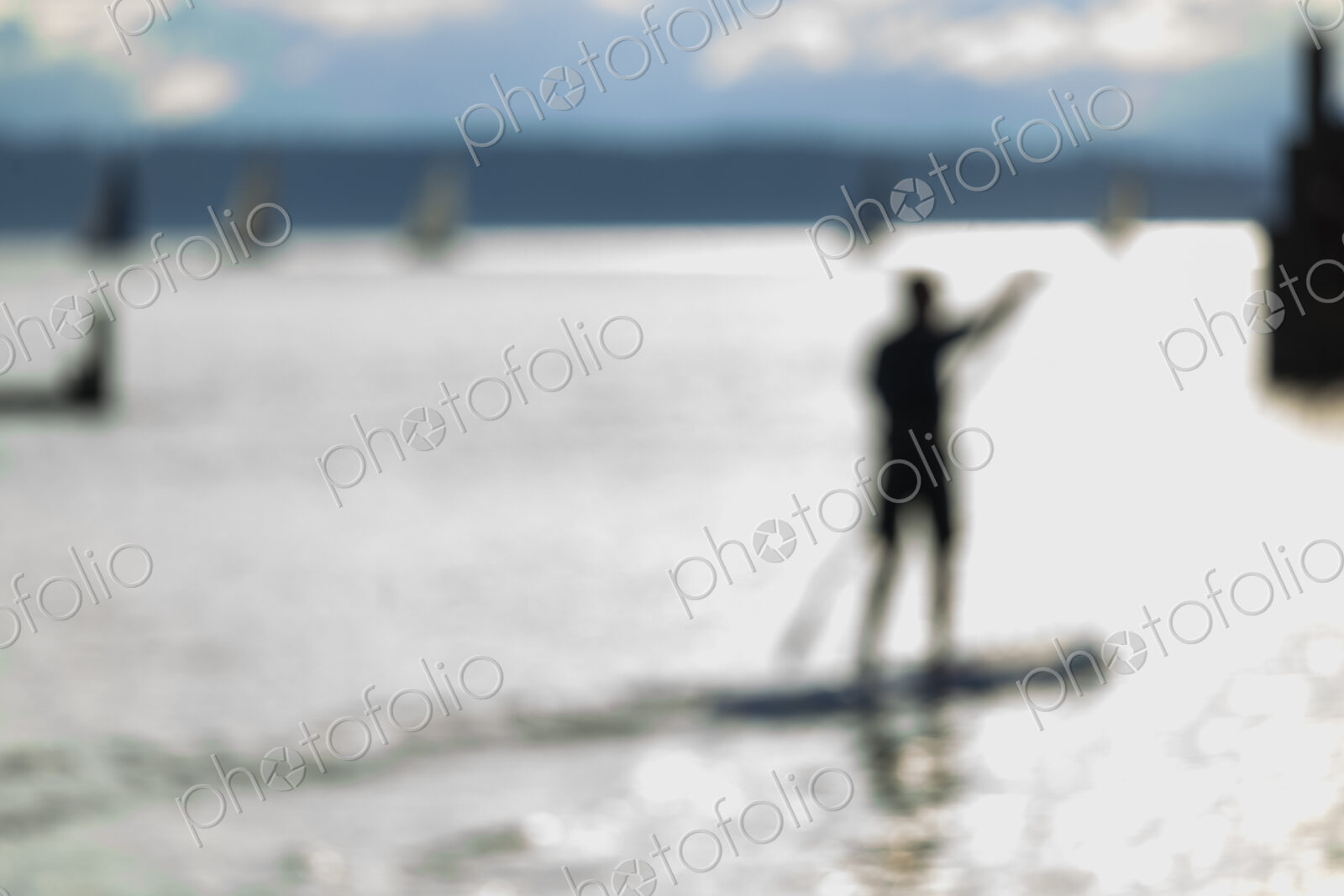 Stand up paddler on the water, blurred motion.