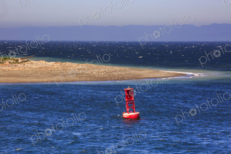 Starboard buoy in the sea off a sandspit at Ediz Hook Port Angeles.