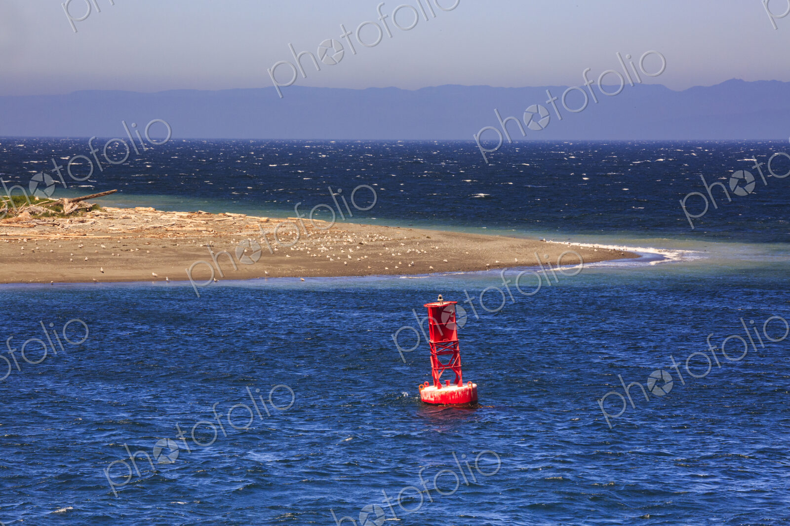 Starboard buoy in the sea off a sandspit at Ediz Hook Port Angeles.