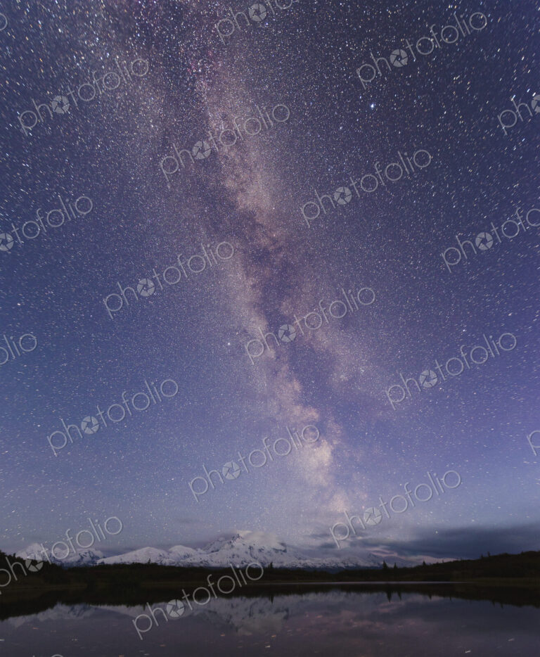 Starry sky over mountain and lake