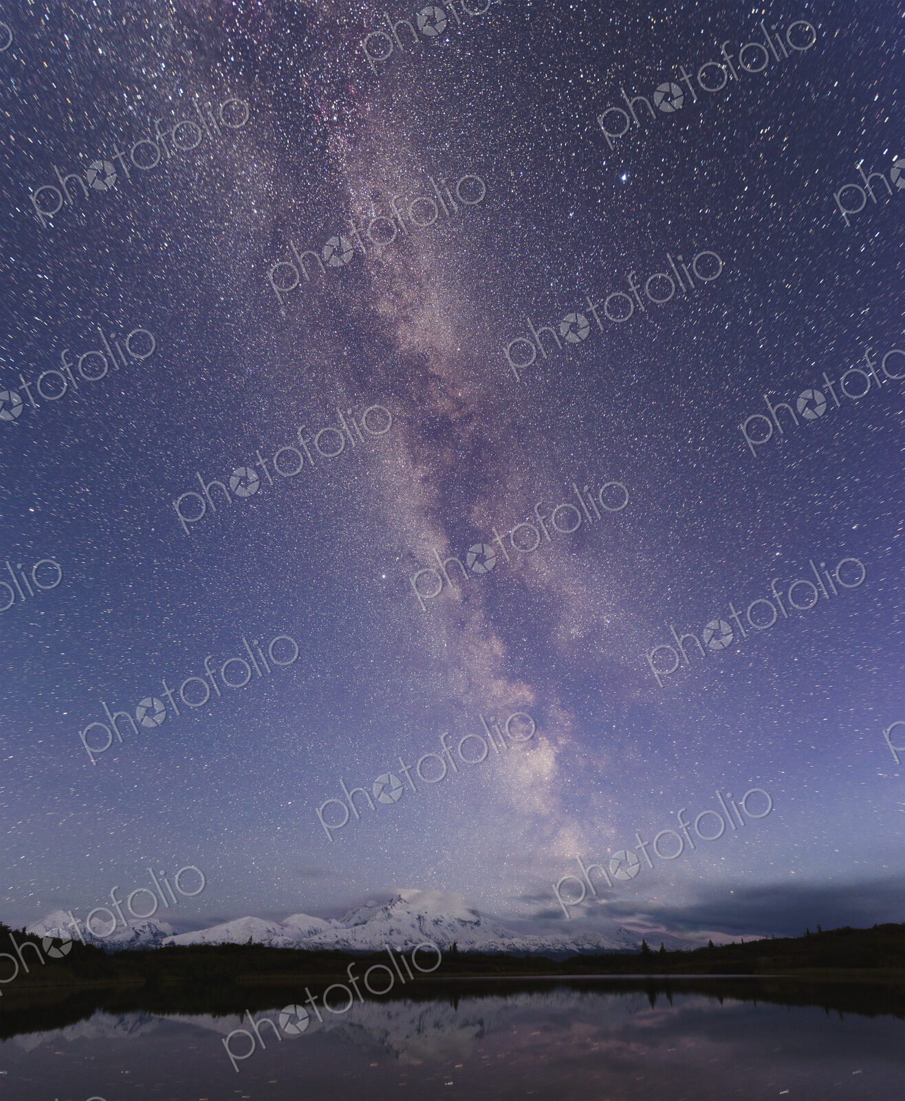 Starry sky over mountain and lake