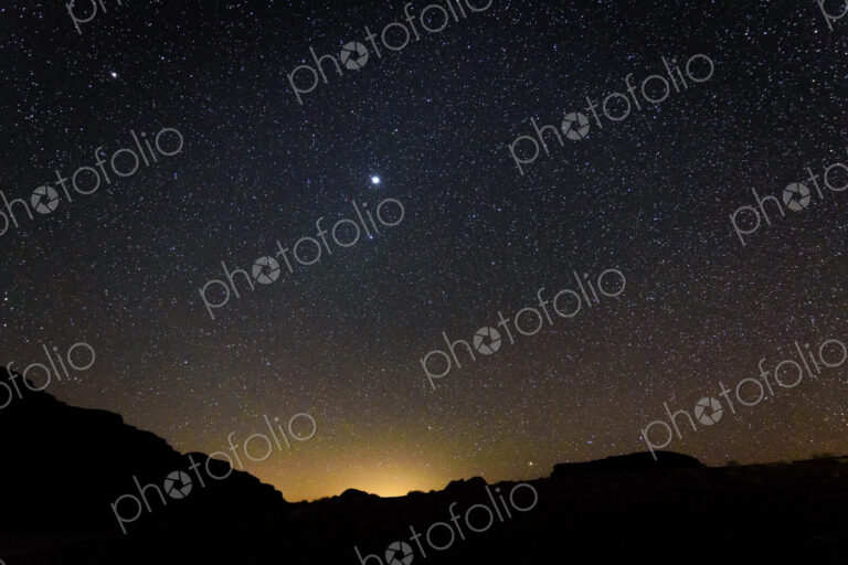 Stars across the sky in the Wadi Rum desert wilderness in southern Jordan at night.