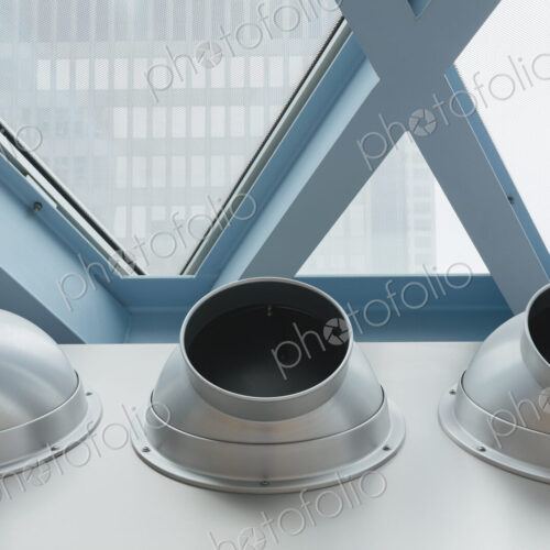 Steel and glass in a building and three metal pipes Steel and glass in a building and three metal pipes