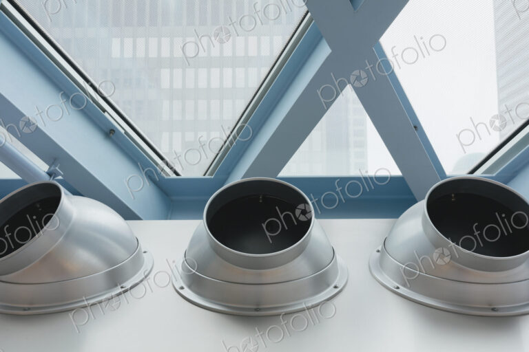 Steel and glass in a building and three metal pipes