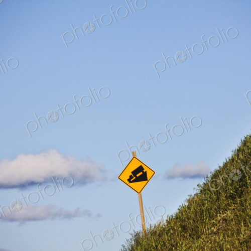 Steep grade caution sign for heavy trucks on the side of the highway in eastern…