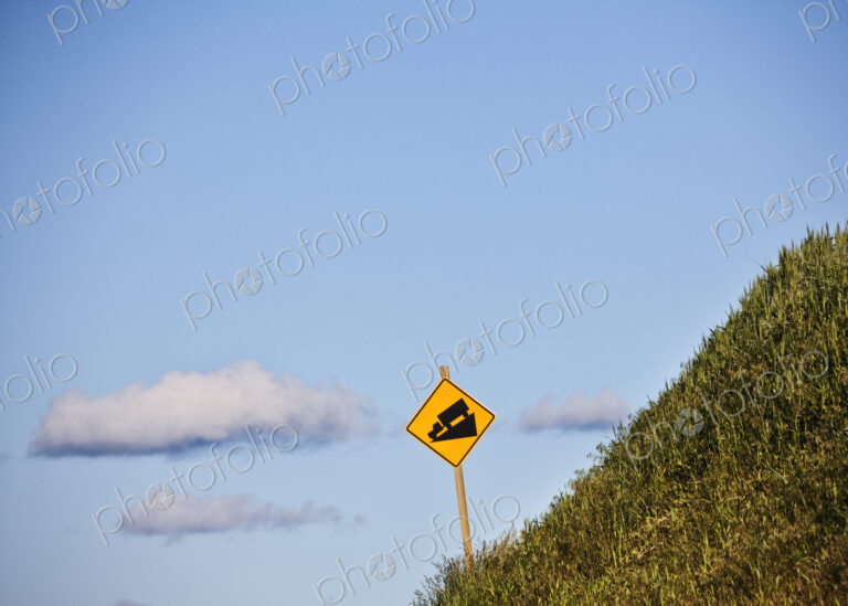 Steep grade caution sign for heavy trucks on the side of the highway in eastern…