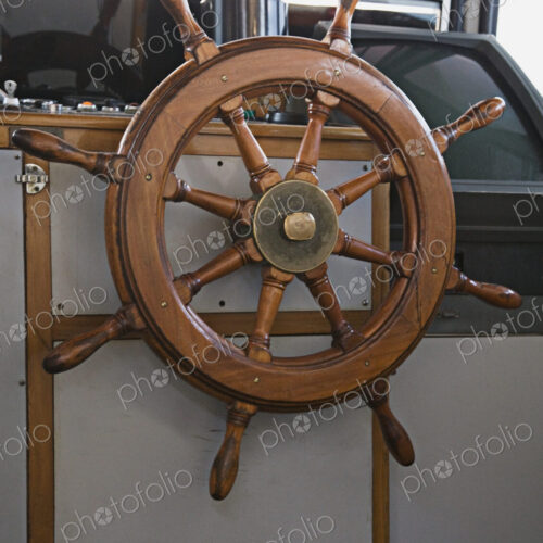 Steering wheel in boat's cabin.