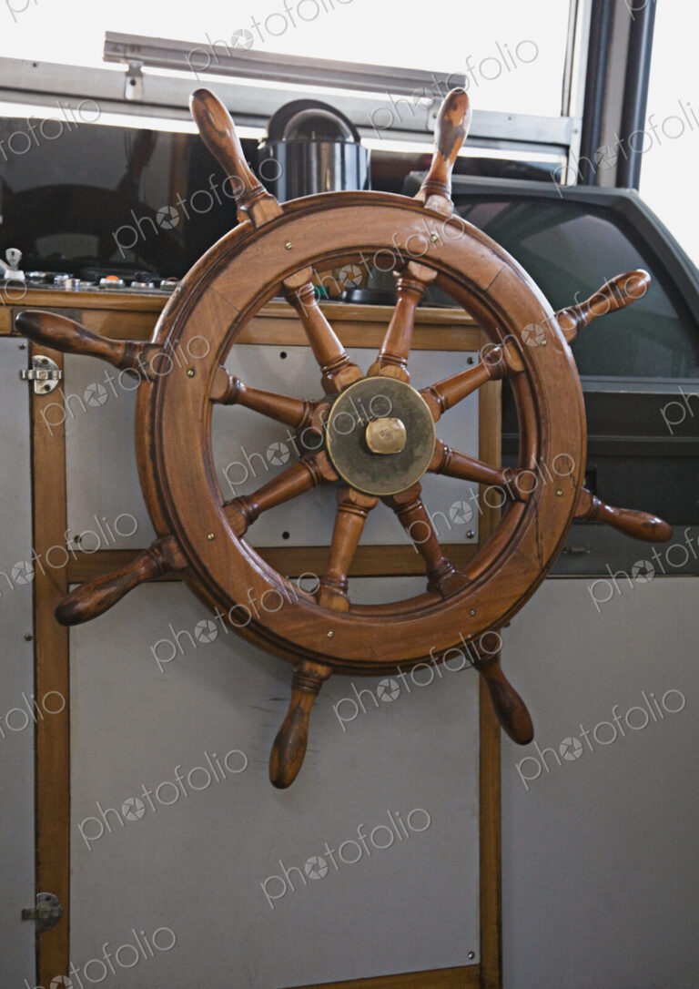 Steering wheel in boat's cabin.