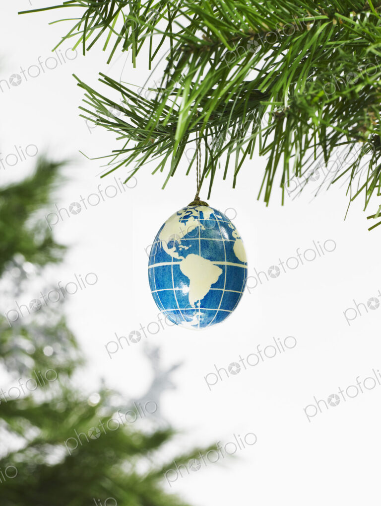 Still life. Green leaf foliage and decorations. A pine tree branch and a blue and…