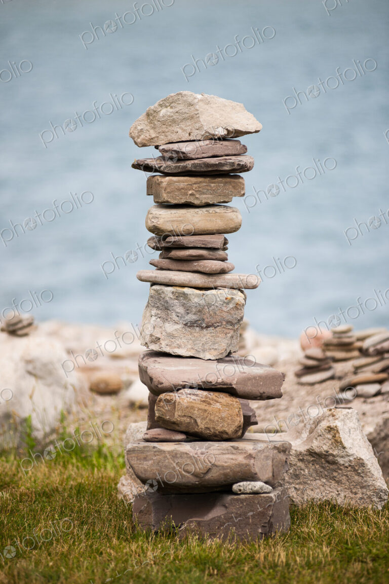 Stones piled up with ocean beyond.