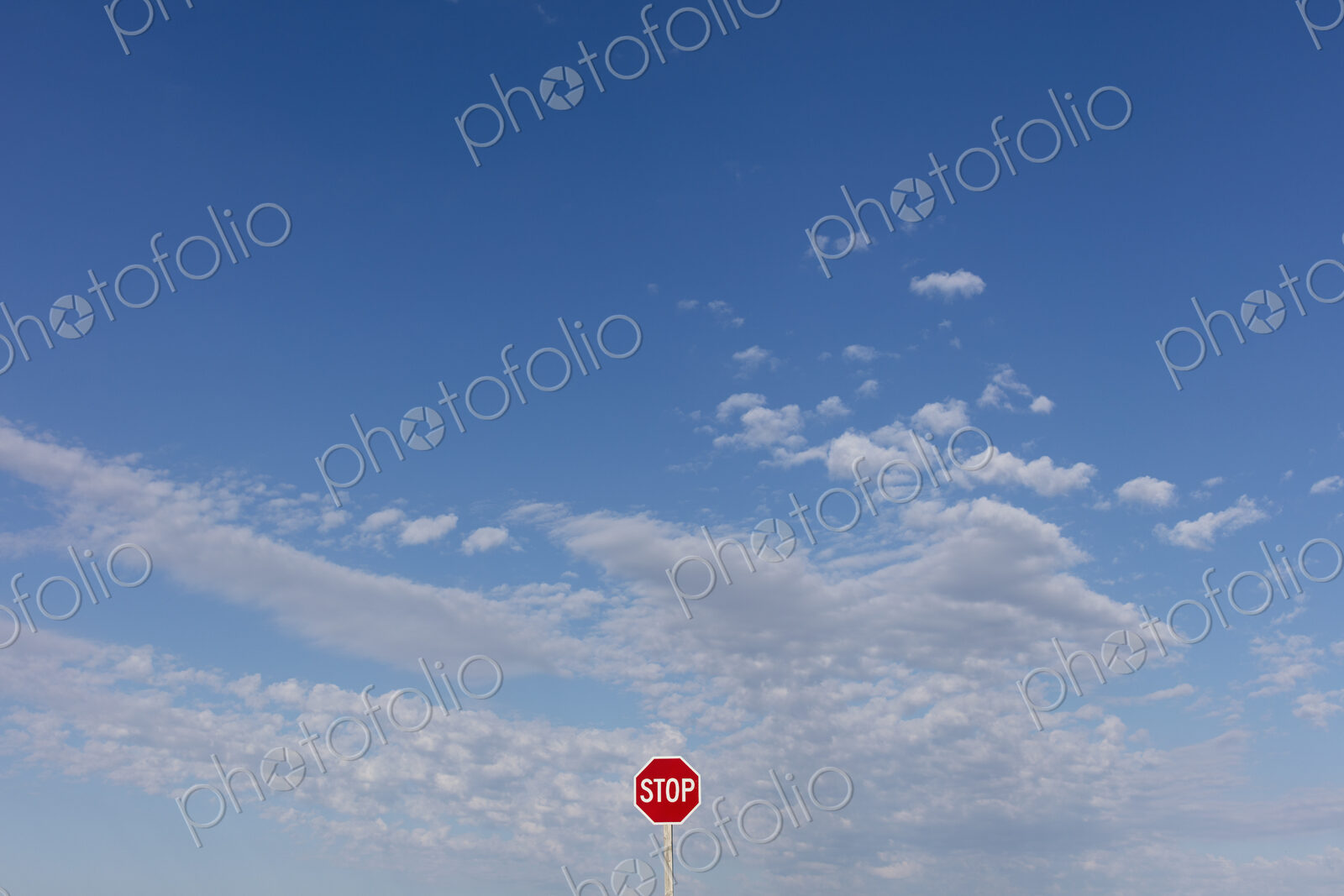 Stop sign and blue sky, near Cadillac, Saskatchewan, Canada.