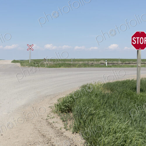 Stop sign and railroad crossing along rural road, Stop sign and railroad crossing along rural road,