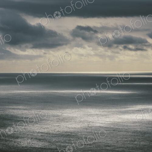 Storm clouds clearing over expansive ocean, dappled sunlight on water, northern Oregon… Storm clouds clearing over expansive ocean, dappled sunlight on water, northern Oregon…