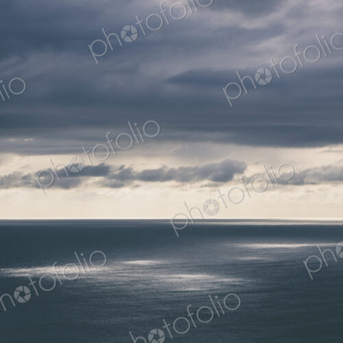 Storm clouds clearing over expansive ocean, dappled sunlight on water, northern Oregon… Storm clouds clearing over expansive ocean, dappled sunlight on water, northern Oregon…