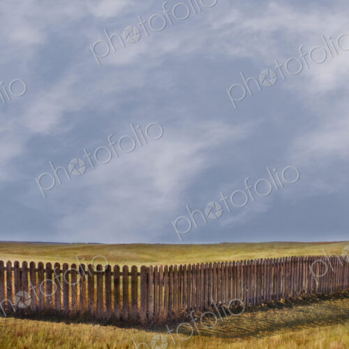 Storm clouds over rural grass fields and fence Storm clouds over rural grass fields and fence
