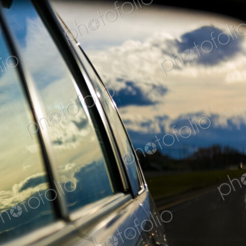 Storm clouds reflection on car windows and side mirror Storm clouds reflection on car windows and side mirror