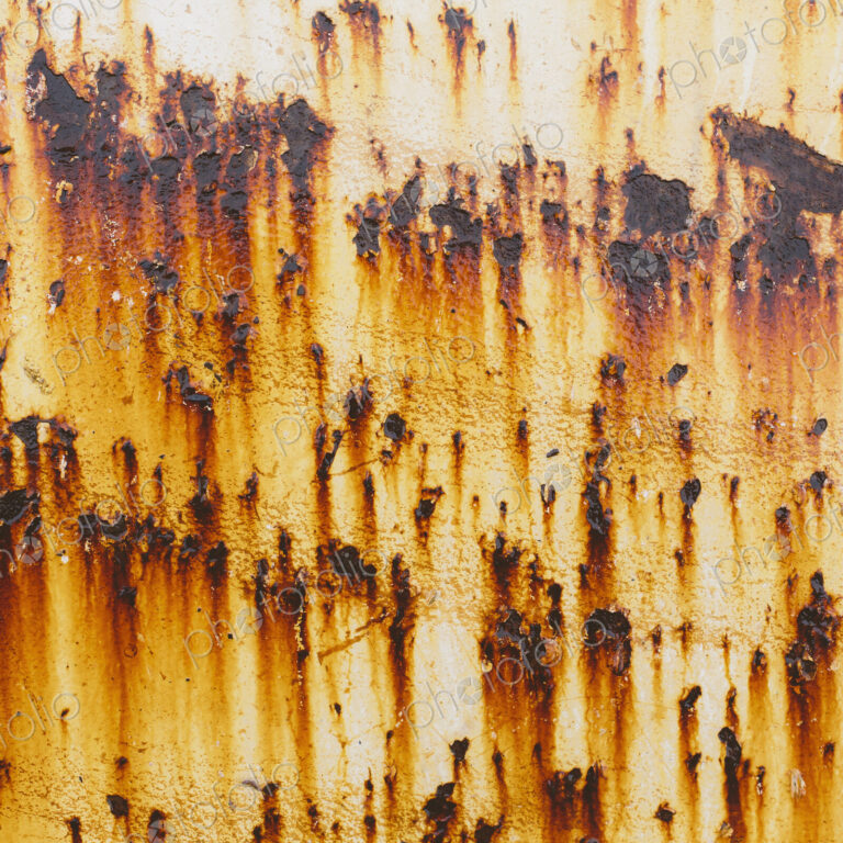 Streaks of rust from steel bolts on a metal sheet.l