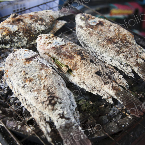 Street food in China town, a small stall with cooked fish in Bangkok, Thailand.