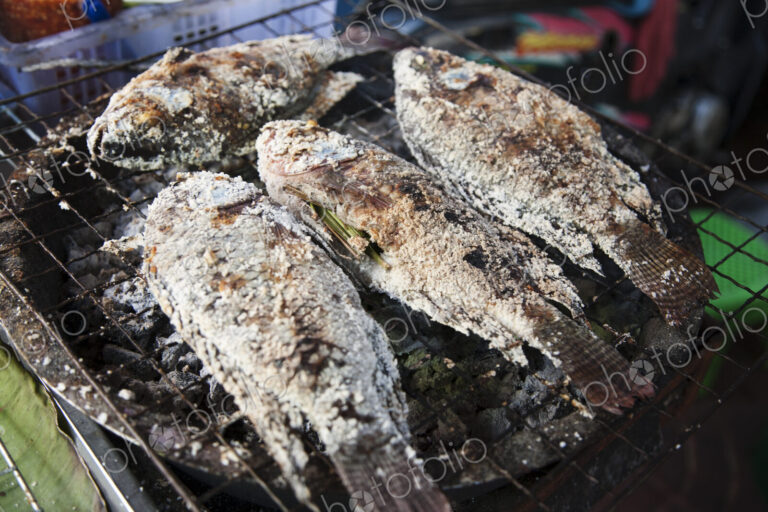 Street food in China town, a small stall with cooked fish in Bangkok, Thailand.